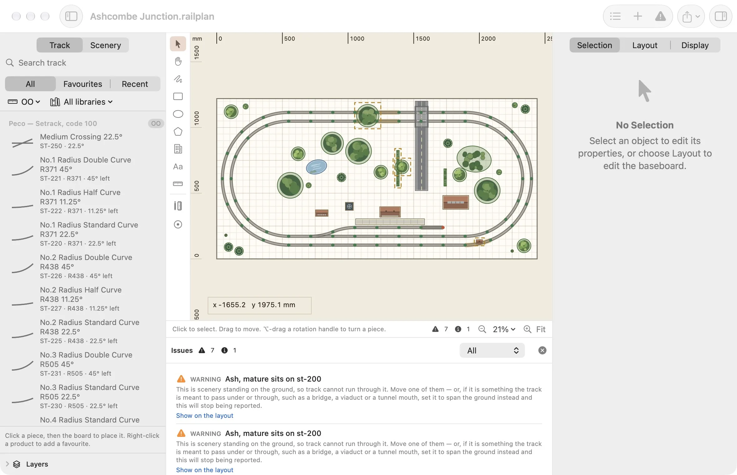 The issues drawer reporting that a tree sits on the track, with the affected objects outlined on the canvas.